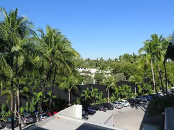 Ultra rich outdoor mall with gorgeous plants, fountains, sculptures, and flowers.