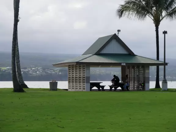Beautiful little park on an island with a white pedestrian bridge.