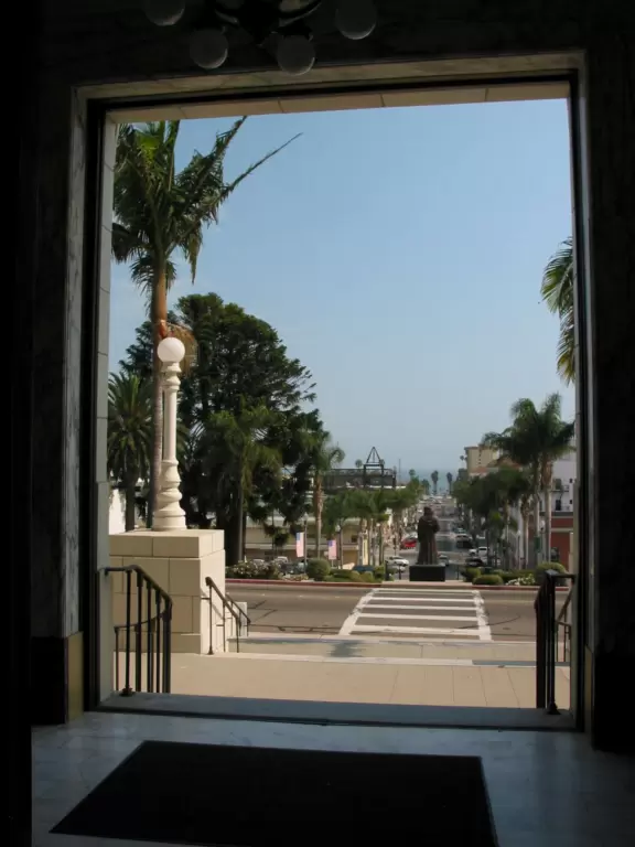 Regal building fronted by palms and flowers atop a pretty hill in downtown Ventura.
