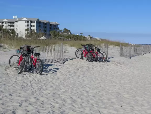 Wide white sand beach with lots of people enjoying the pleasant vibe. Bench swings and splash pad.