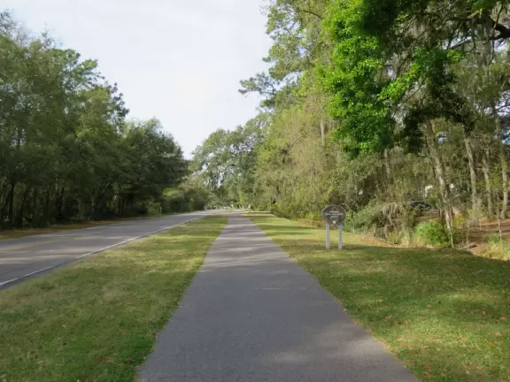Gorgeous shady bike paths under trees strung with Spanish moss, with borders of flowers, over boardwalks with swamps below.
