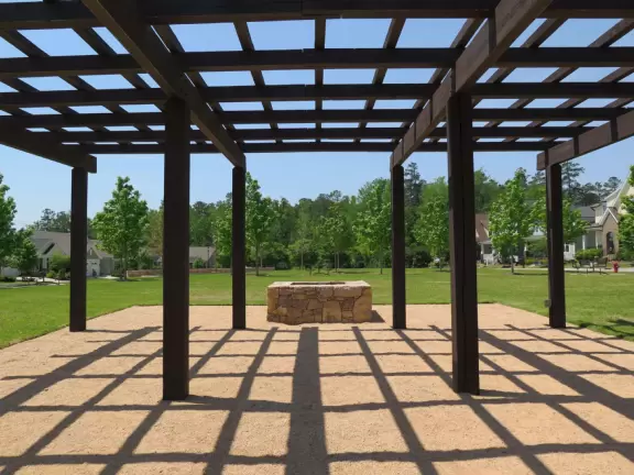 Recent, shadeless housing development with a few playgrounds.