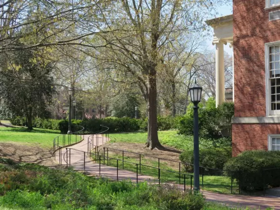 Historic buildings, sunny quad where students hang out, flowers and old trees, and fun student center area.