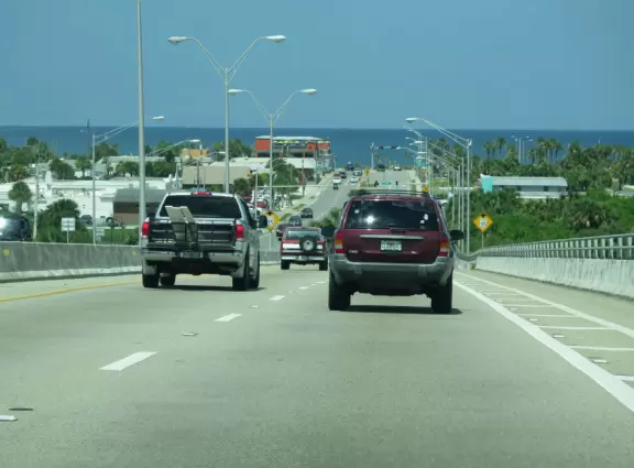 Absolutely gorgeous beach with blue-green water and yellow sand, and a fishing pier.