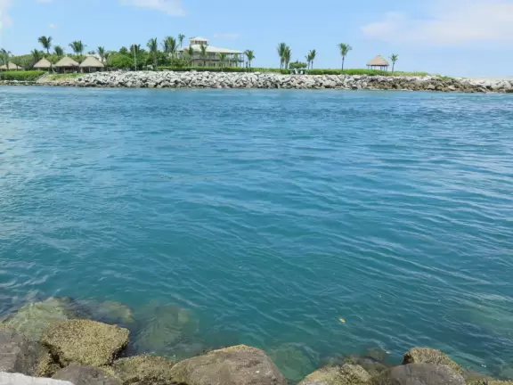 Beach where fishermen hang out on the jetty and surfers come to ride the waves at Jupiter Inlet.