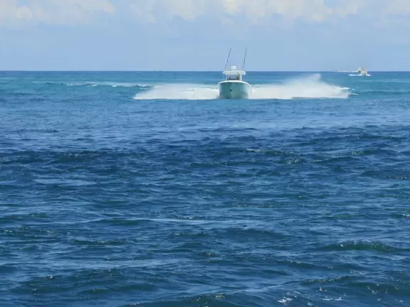 Beach where fishermen hang out on the jetty and surfers come to ride the waves at Jupiter Inlet.