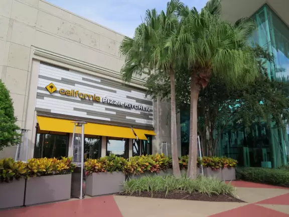 Impressive indoor mall with fountains and curved TV screens.