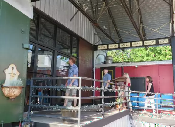 Health food store with great bakery, indoor seating with&nbsp;big windows, and outdoor picnic tables under thick leafy shade.