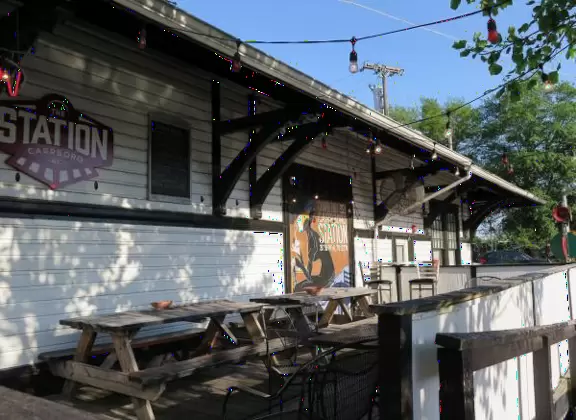 Health food store with great bakery, indoor seating with&nbsp;big windows, and outdoor picnic tables under thick leafy shade.