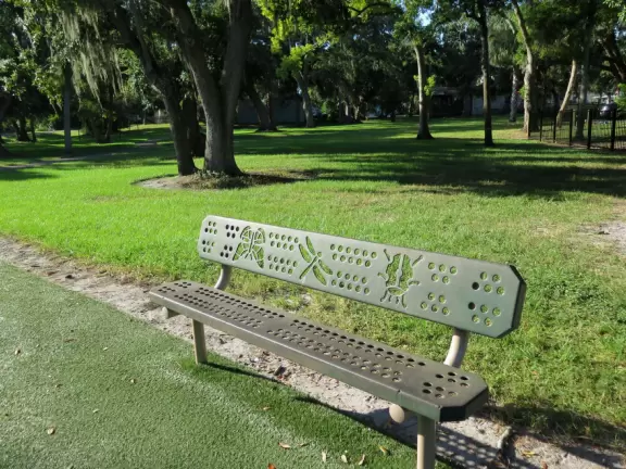 Lovely forest-themed playground, along the bike path, with water and pier across the street.