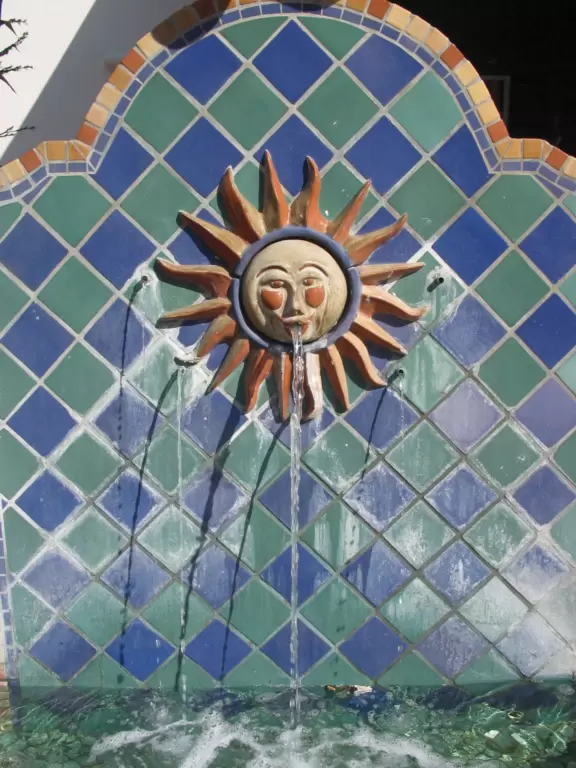 Street with beautiful historic arcades, cafes, and Spanish architecture.