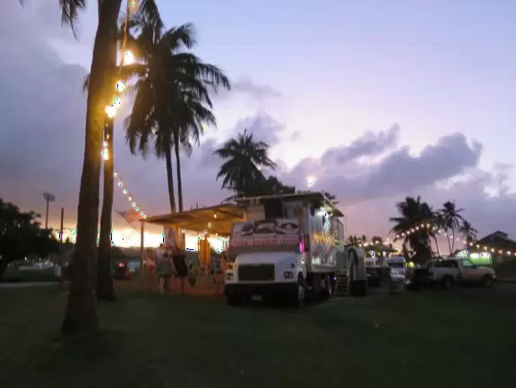 Magical little spot with grassy hills, strung lights, picnic tables, and food trucks.