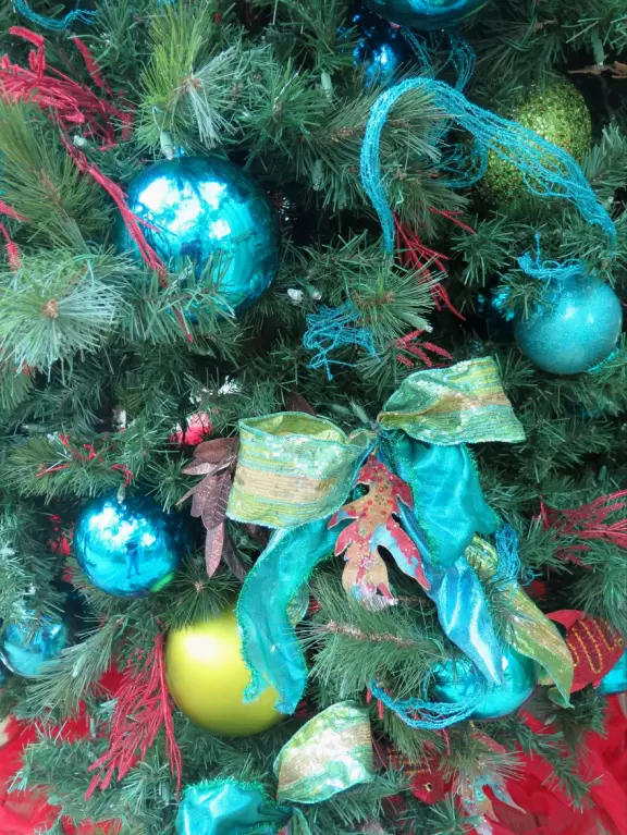 Hotel inside a giant atrium with tropical plants, fish, alligators, and decorations. ICE sculpture event in December.
