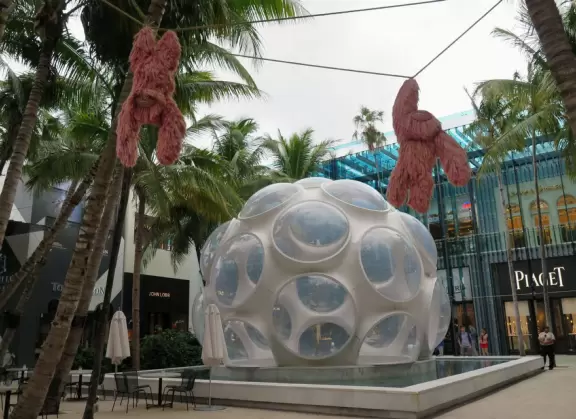 Beautiful architecture, sculptures, modern art museum, designer stores, play equipment, and public market with swings.