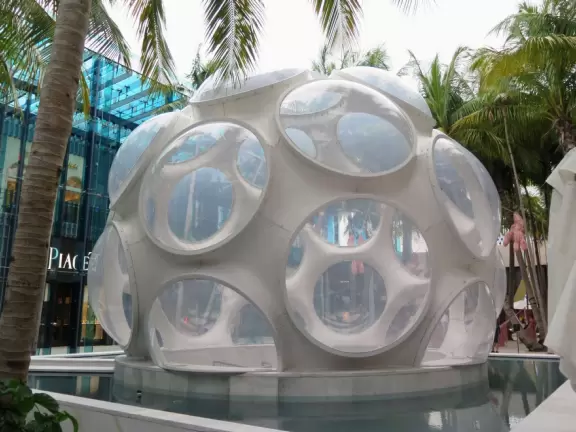 Beautiful architecture, sculptures, modern art museum, designer stores, play equipment, and public market with swings.