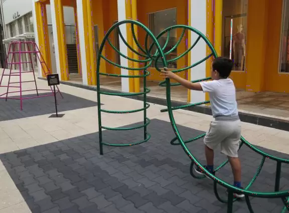 Beautiful architecture, sculptures, modern art museum, designer stores, play equipment, and public market with swings.