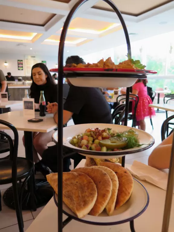 Beautiful architecture, sculptures, modern art museum, designer stores, play equipment, and public market with swings.