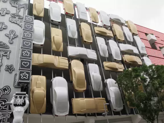 Beautiful architecture, sculptures, modern art museum, designer stores, play equipment, and public market with swings.