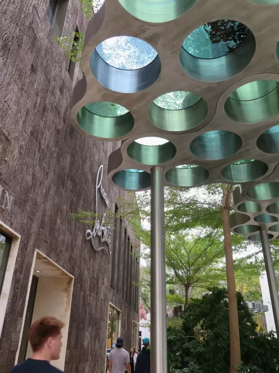 Beautiful architecture, sculptures, modern art museum, designer stores, play equipment, and public market with swings.