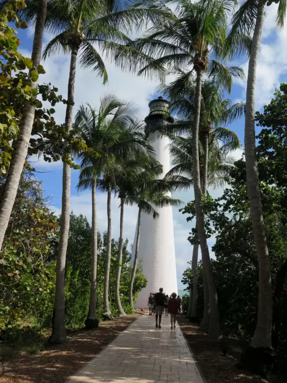 White lighthouse with blue-green water behind- a gorgeous sight! And easy to climb!