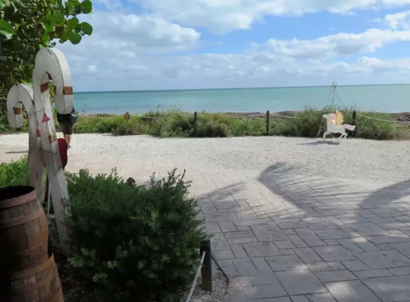 White lighthouse with blue-green water behind- a gorgeous sight! And easy to climb!