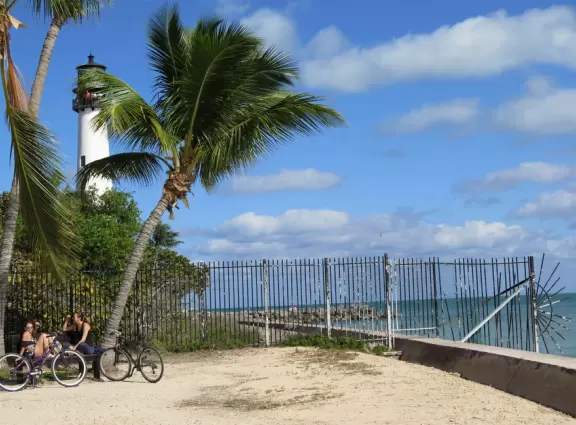 White lighthouse with blue-green water behind- a gorgeous sight! And easy to climb!