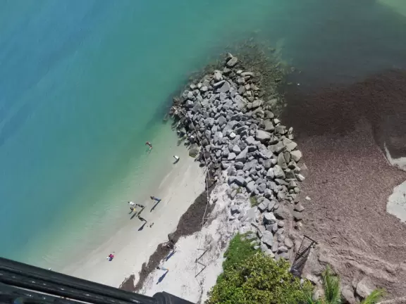 White lighthouse with blue-green water behind- a gorgeous sight! And easy to climb!
