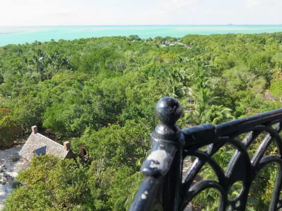 White lighthouse with blue-green water behind- a gorgeous sight! And easy to climb!