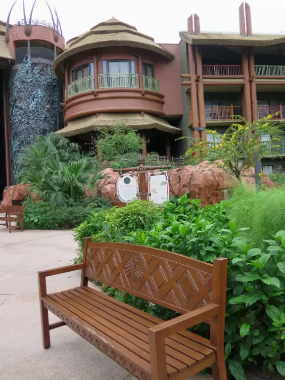 Theme park hotel with African music, tropical plants, African furniture and decorations, African items on display, and animals roaming outside the windows and outdoor viewing areas!