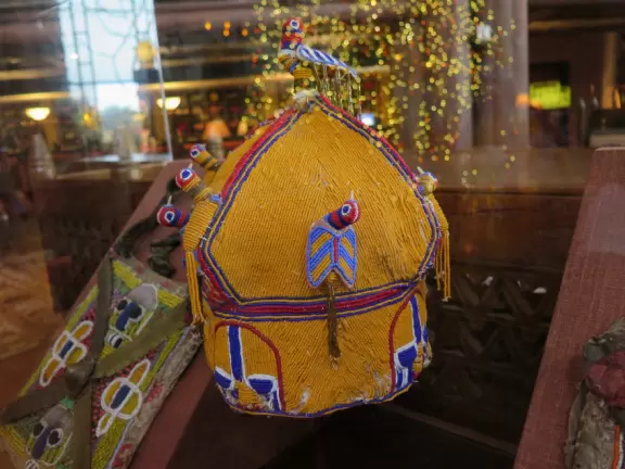 Theme park hotel with African music, tropical plants, African furniture and decorations, African items on display, and animals roaming outside the windows and outdoor viewing areas!