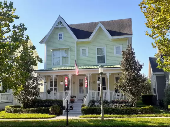 A popular town center with sidewalk cafes leading down to a pretty lake with a walking path.