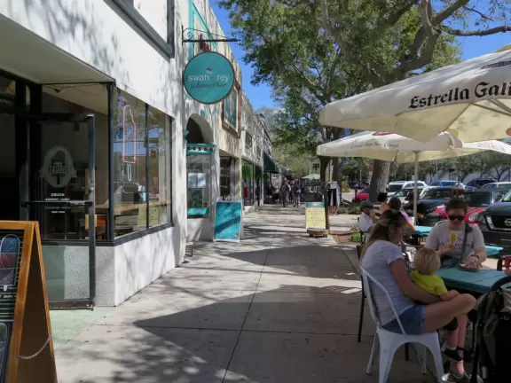 Lovely main street with many sidewalk cafes and young people.
