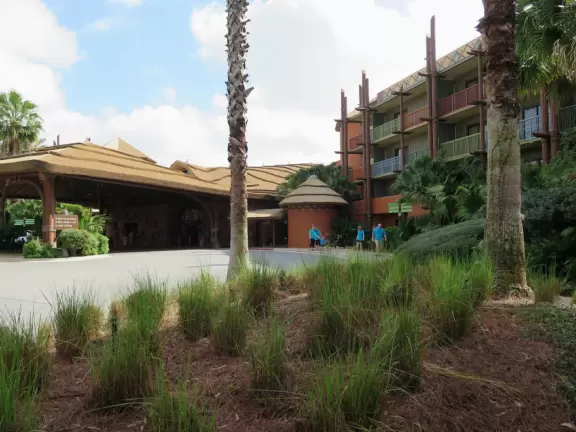 Theme park hotel with African music, tropical plants, African furniture and decorations, African items on display, and animals roaming outside the windows and outdoor viewing areas!