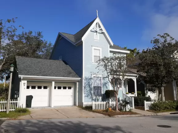 A popular town center with sidewalk cafes leading down to a pretty lake with a walking path.