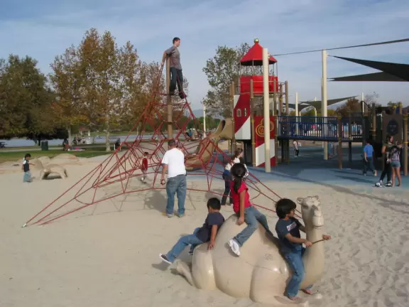 A huge wonderful park with a new playground that is out of this world, a lake with paddle boats, and plenty of trees and grass.