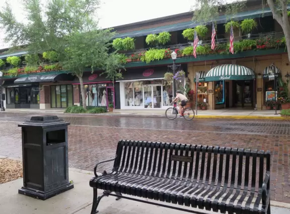 Gorgeous main street with large, European-style park where people sit on the grass by the fountain.