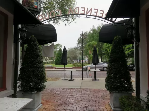 Gorgeous main street with large, European-style park where people sit on the grass by the fountain.