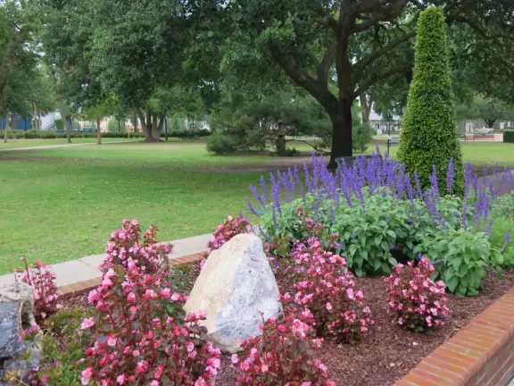 Gorgeous main street with large, European-style park where people sit on the grass by the fountain.