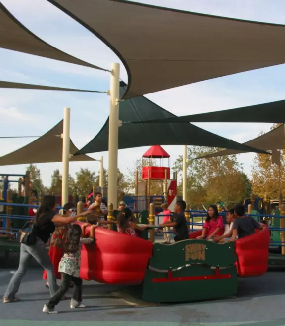 A huge wonderful park with a new playground that is out of this world, a lake with paddle boats, and plenty of trees and grass.