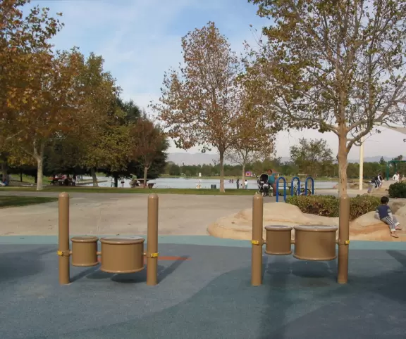 A huge wonderful park with a new playground that is out of this world, a lake with paddle boats, and plenty of trees and grass.