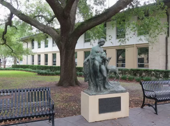 Gorgeous main street with large, European-style park where people sit on the grass by the fountain.