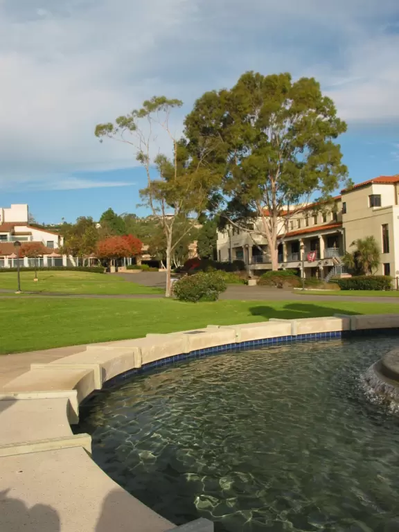 A huge green lawn looking out over the bright blue ocean and Leadbetter Beach.