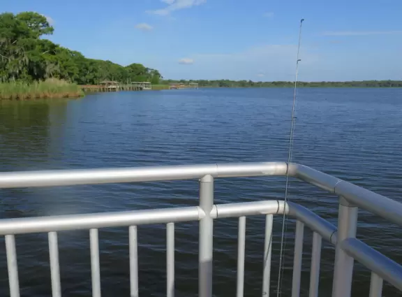 Huge park for events, with sports fields surrounded by adorable hills, dog park with doggy playground, metal/concrete pier on the lake, and three-storey playground.