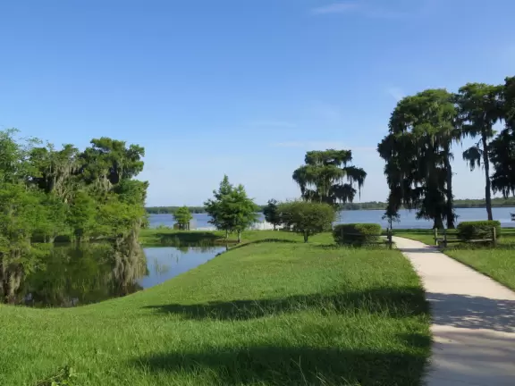 Huge park for events, with sports fields surrounded by adorable hills, dog park with doggy playground, metal/concrete pier on the lake, and three-storey playground.
