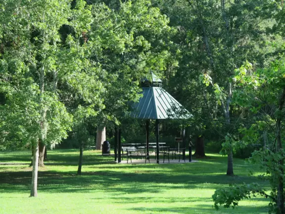 Popular park for biking and fishing, with a river and small dam.