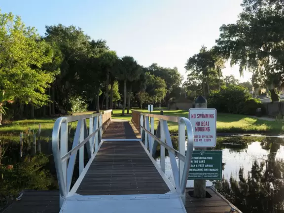Lovely walk under huge oaks with tropical vines, past docks and lake views.