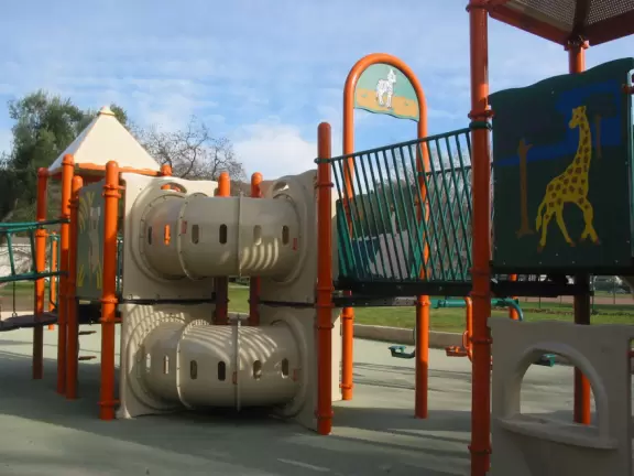 A wonderful neighborhood park with huge oak trees, winding paths, and a super fun new playground.