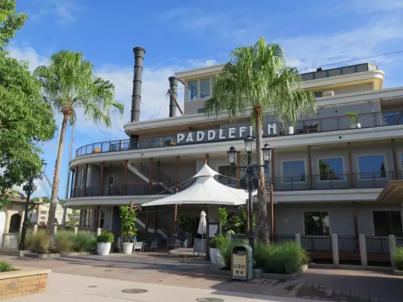 Waterfront area with restaurants, live street performers, entertainment, toy stores, and carousel.