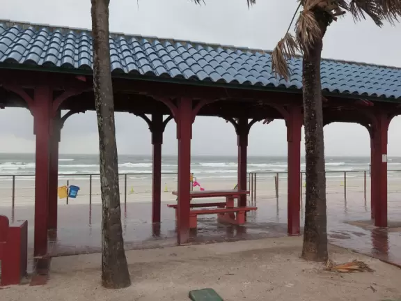 Cute, walkable street with cafes, gift shops, and a surf shop, ending at the beach boardwalk.