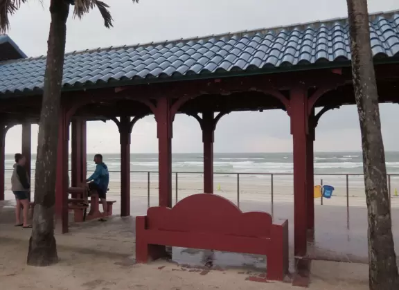 Cute, walkable street with cafes, gift shops, and a surf shop, ending at the beach boardwalk.